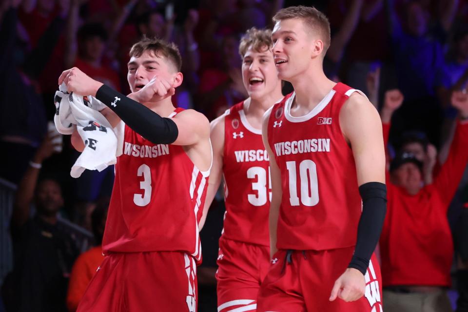 Badgers guard Connor Essegian (3) celebrates with teammates after the game against the Dayton Flyers.