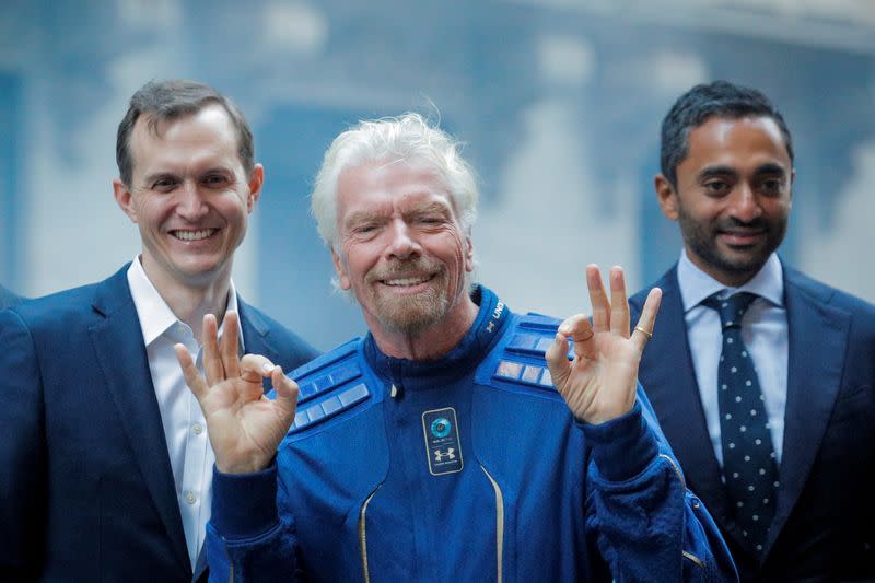 FILE PHOTO: Virgin Galactic co-founder Sir Richard Branson, CEO George Whitesides and Social Capital CEO Chamath Palihapitiya pose together outside of the NYSE as Virgin Galactic (SPCE) begins public trading in New York