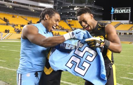 Nov 16, 2017; Pittsburgh, PA, USA; Tennessee Titans cornerback Adoree' Jackson (left) and Pittsburgh Steelers wide receiver JuJu Smith-Schuster (right) react as they exchange jerseys after their game at Heinz Field. The Steelers won 40-17. Mandatory Credit: Charles LeClaire-USA TODAY Sports