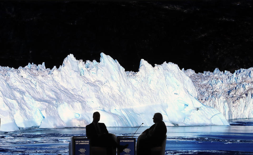 Britain's Prince William, left, and Sir David Attenborough, broadcaster and natural historian, watch the screening of Attenborough's new documentary "Our Planet" during a session at the annual meeting of the World Economic Forum in Davos, Switzerland, Tuesday, Jan. 22, 2019. (AP Photo/Markus Schreiber)