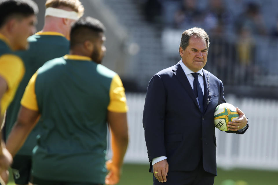 FILE - Australia's rugby coach Dave Rennie, right, watches his players warm up ahead of the Rugby Championship game against New Zealand in Perth, Australia, on Sept. 5, 2021. Rugby Australia said Monday, Jan. 16, 2023, it has hired Eddie Jones to be the head coach of the Wallabies and that current head coach Rennie "will depart the position." (AP Photo/Gary Day, File)