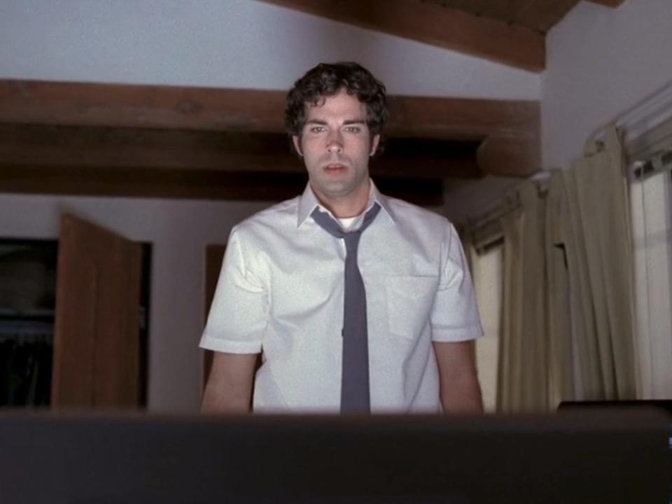 zachary levi in a white shirt and grey tie on chuck, looking at a computer screen