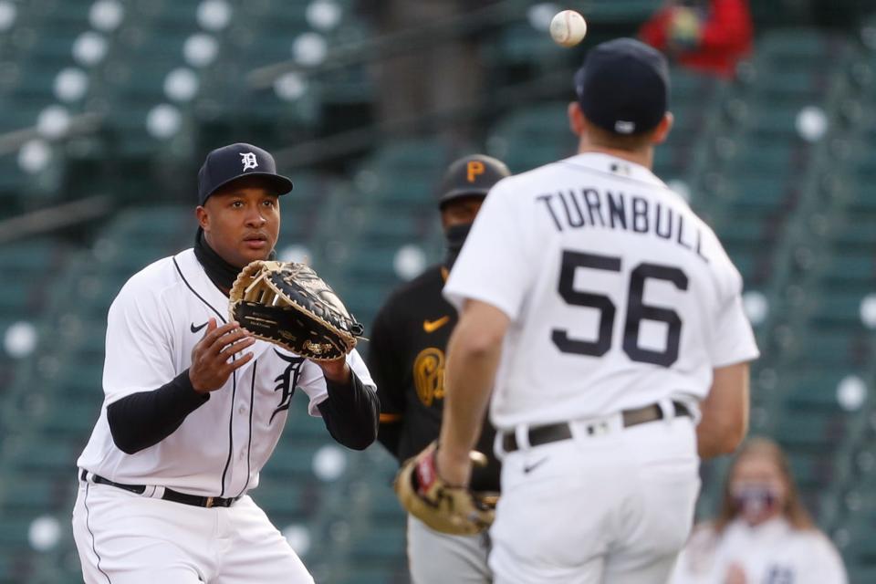 Tigers pitcher Spencer Turnbull tosses the ball to first baseman Jonathan Schoop for an out during the first inning of the 5-2 win over the Pirates in Game 2 of the doubleheader on Wednesday, April 21, 2021, at Comerica Park.