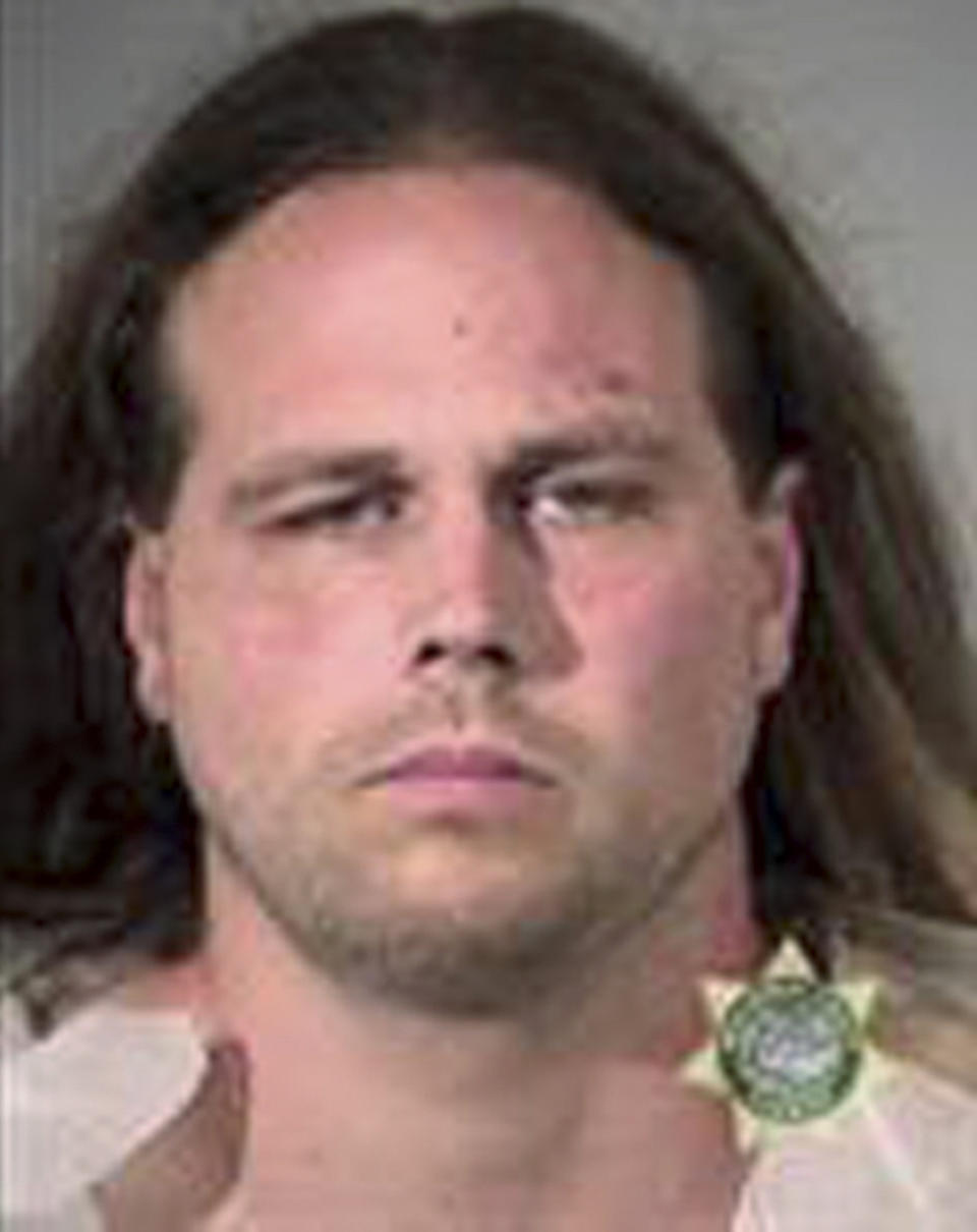 FILE - This undated file booking photo provided by Multnomah County Sheriff's Office shows Jeremy Christian. Christian, charged with fatally stabbing two men who authorities say confronted him during a racist rant on a Portland, Oregon light-rail train, goes to trial Tuesday, Jan. 21, 2020, two years after the killings that plunged this liberal city into months of soul-searching. (Multnomah County Sheriff's Office via AP, File)