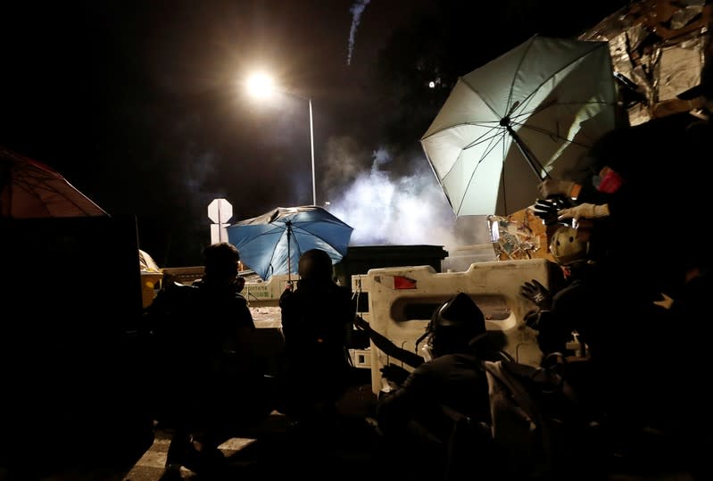 Protesters form a barricade during a standoff with riot police at the Chinese University of Hong Kong