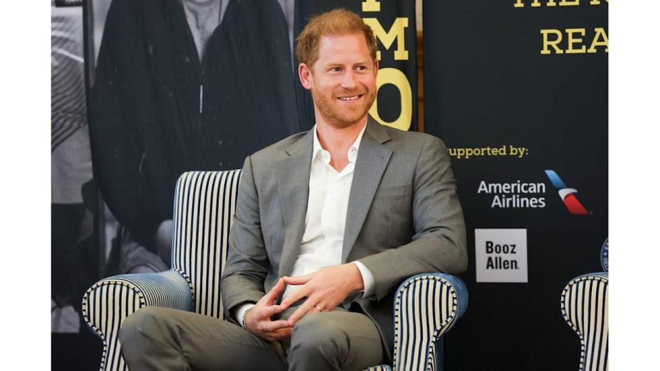 Prince Harry sitting in a striped armchair