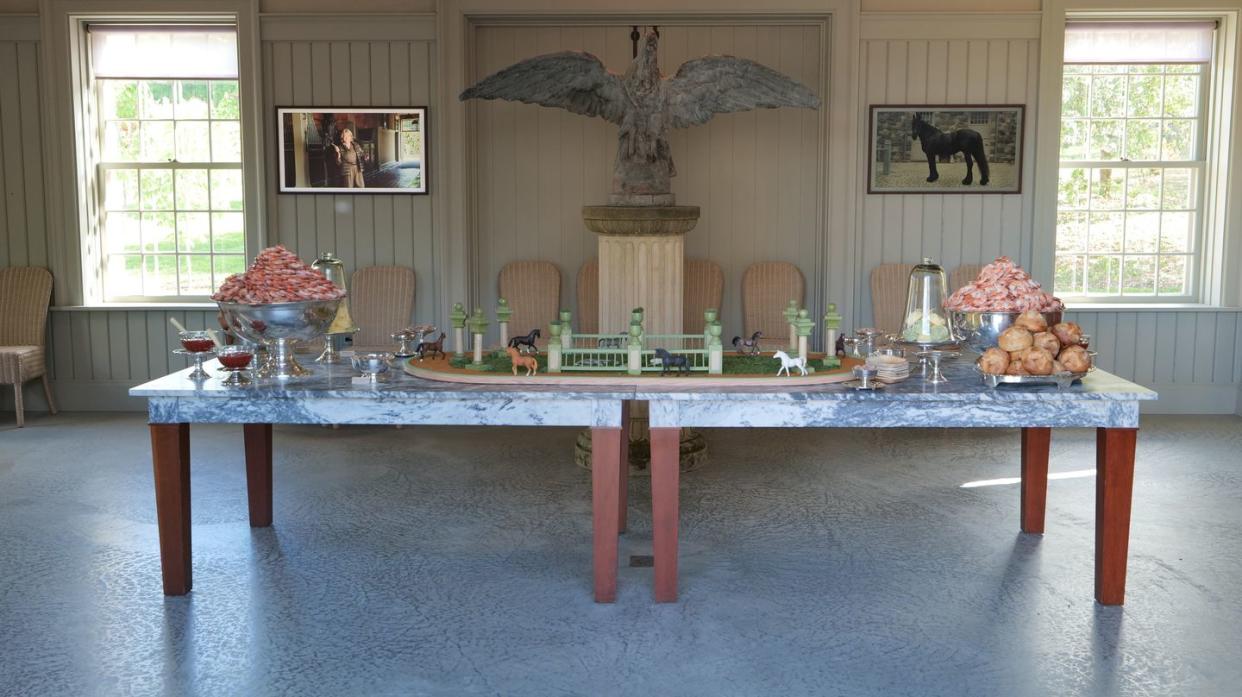 a table with a blue tablecloth and a blue table with a vase and a vase with flowers