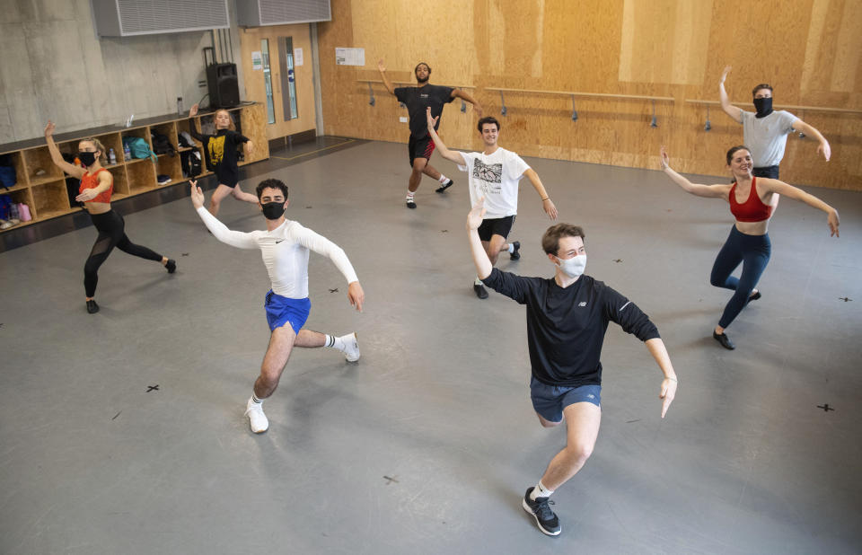 Students observe social distancing with some wearing face masks, as they take part in a dance session as classes resume at Mountview Academy of Theatre Arts drama school following its closure due to coronavirus, in Peckham, south London, Tuesday, Sept. 8, 2020. (Dominic Lipinski/PA via AP)