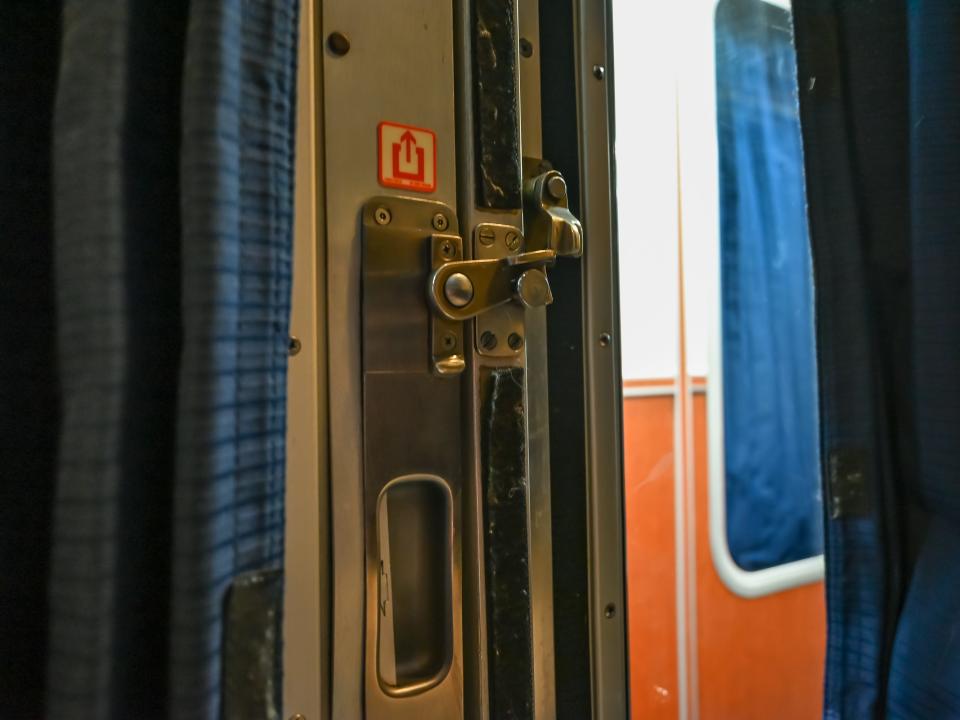 Latch on a metal door to an Amtrak sleeper car