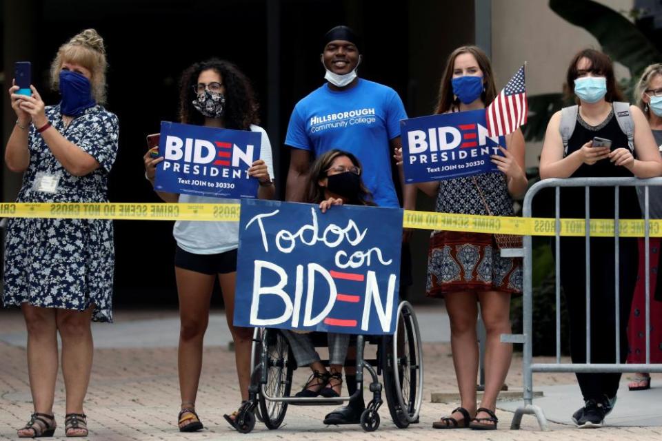 Joe Biden delivers remarks and holds a roundtable discussion with veterans at Hillsborough Community College in Tampa, Florida, as his supporters stand outside on 15 September.