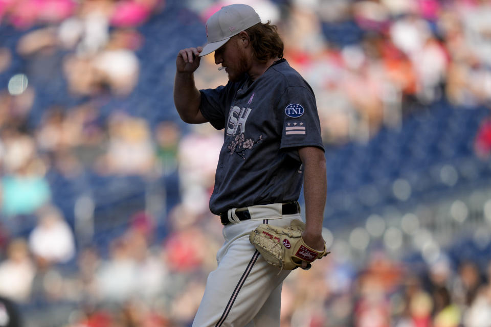 Washington Nationals relief pitcher Mason Thompson reacts on the mound after walking a run during the fifth inning of a baseball game against the New York Mets at Nationals Park, Sunday, May 14, 2023, in Washington. (AP Photo/Alex Brandon)