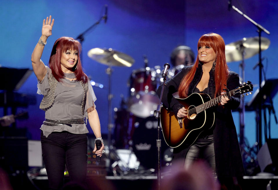 FILE - Naomi Judd, left, and Wynonna Judd, of The Judds, perform at the "Girls' Night Out: Superstar Women of Country," in Las Vegas, April 4, 2011. Fans will have a chance to say goodbye to Naomi Judd, the late matriarch of the Grammy-winning country duo The Judds, on a tour starting Friday. Wynonna Judd will helm the 11-city tour. (AP Photo/Julie Jacobson, File)