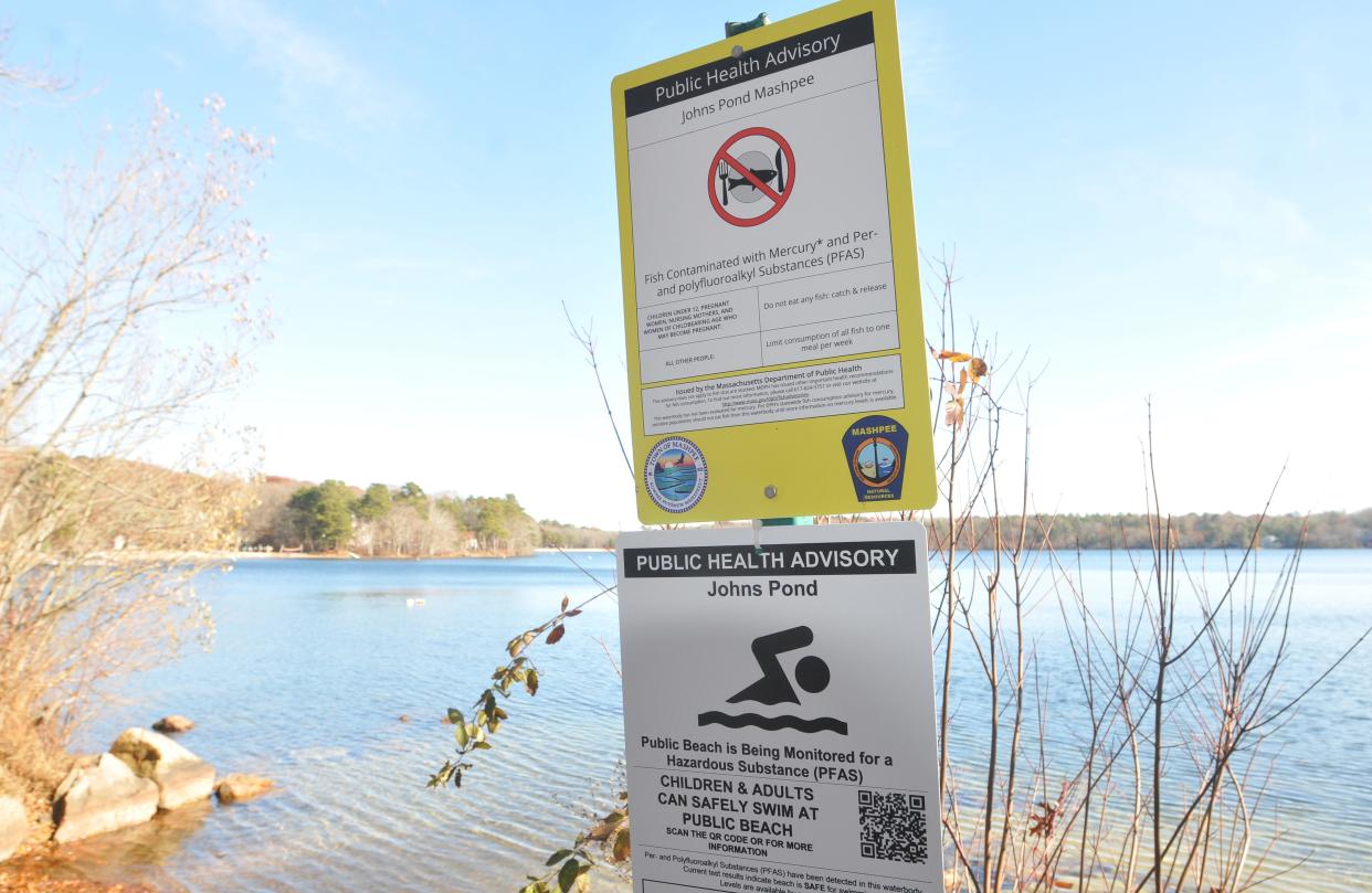 A sign at Johns Pond in Cape Cod warns against eating locally caught fish due to PFAS contamination.
