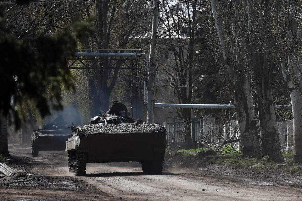 Ukrainian BMP infantry fighting vehicles ride along a street in the town of Chasiv Yar, Donetsk region, on 16 April 2023, amid the Russian invasion of Ukraine (AFP via Getty Images)