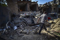 FILE - In this Oct. 13, 2020, file photo, a man walks among the debris of damaged houses two days after shelling by Armenian artillery in Ganja, Azerbaijan. A Russian attempt to broker a cease-fire to end the worst outbreak of hostilities over the region of Nagorno-Karabakh in more than a quarter-century has failed to get any traction, with Azerbaijan and Armenia trading blame for new attacks. (Ismail Coskun/IHA via AP, File)