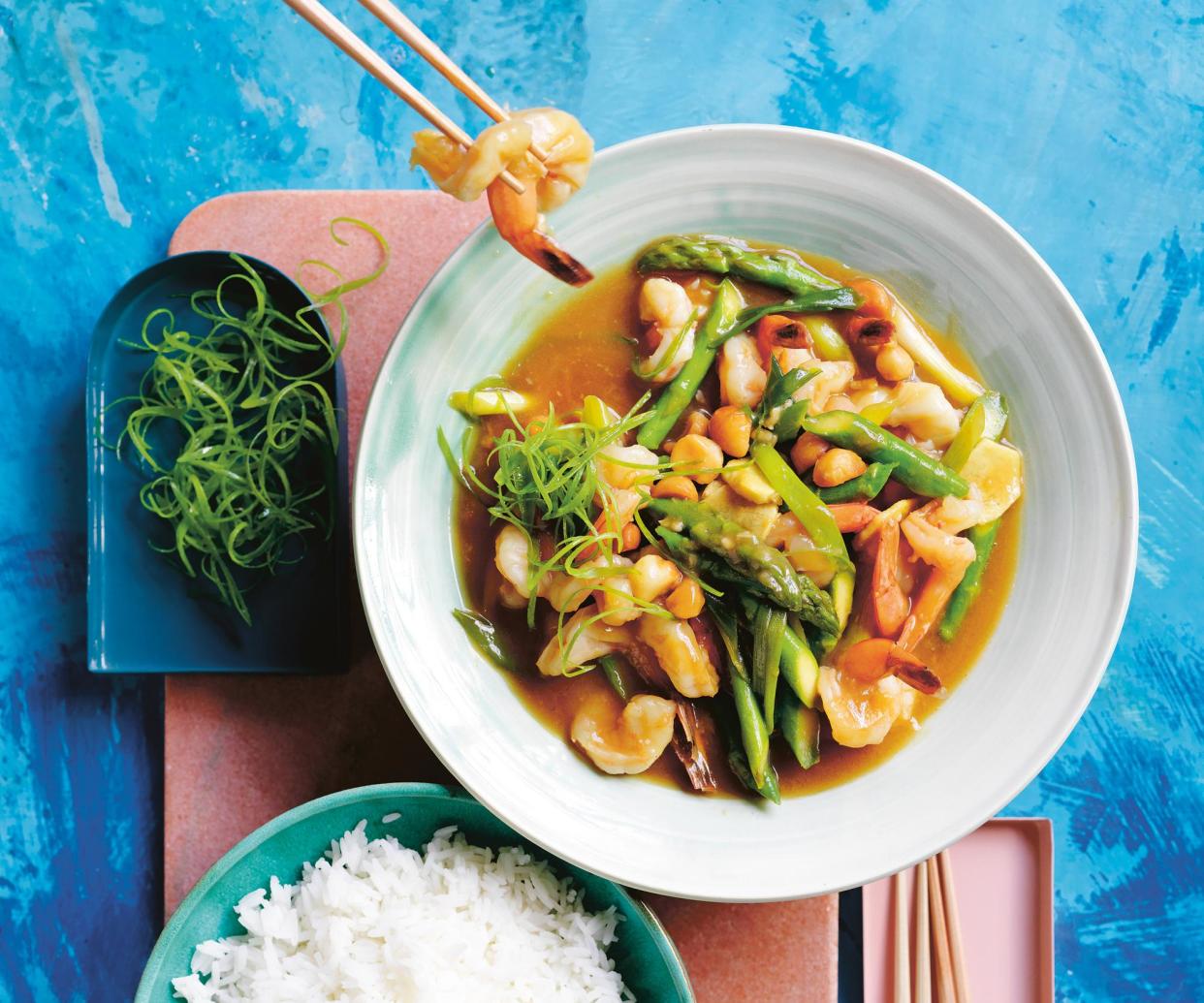 <span>‘The kind of dish you’ll have memorised and added to your repertoire in no time’: Alice Zaslavsky’s prawn, macadamia and asparagus stir fry.</span><span>Photograph: Benjamin Dearnley</span>