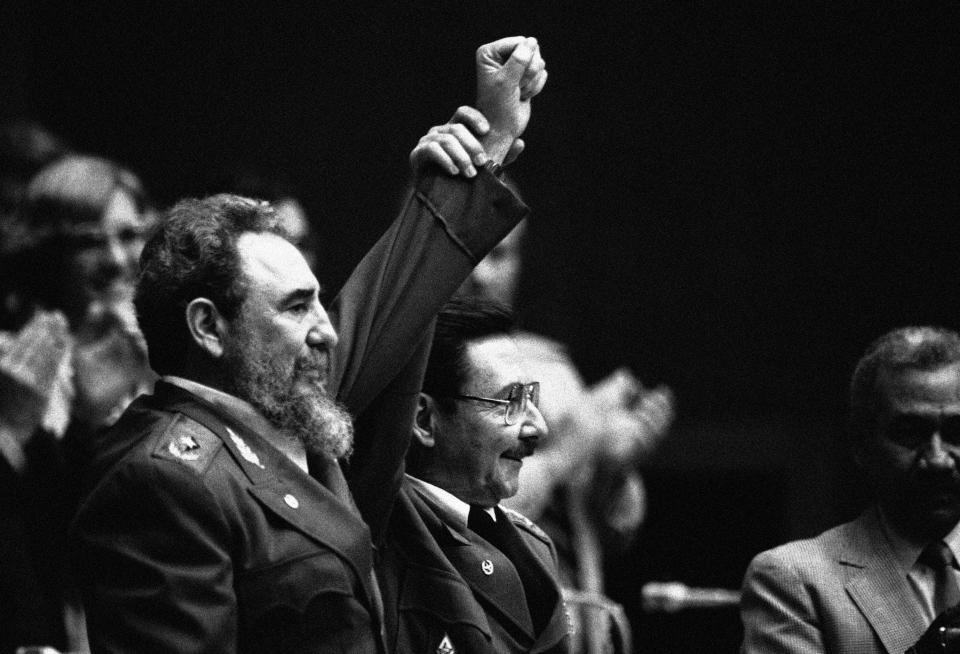 FILE - In this Feb. 8, 1986 file photo, Cuban President Fidel Castro, left, joins hands with his younger brother Raul Castro, chief of the Cuban Armed Forces and first vice president, after the two were reelected during the 3rd Cuban Communist Party Congress session in Havana, Cuba. For most of his life, Raul Castro played second-string to his brother, but for the past decade, it’s Raul who's been the face of communist Cuba. On Friday, April 16, 2021, Raul Castro formally announced he'd step down as head of the Communist Party, leaving Cuba without a Castro in an official position of command for the first time in more than six decades. (AP Photo/Charles Tasnadi, File)