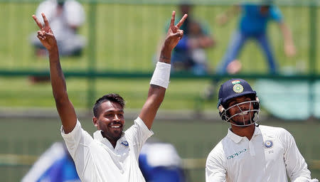 Cricket - Sri Lanka v India - Third Test Match - Pallekele, Sri Lanka - August 13, 2017 - India's Hardik Pandya celebrates his century next to his teammate Umesh Yadav. REUTERS/Dinuka Liyanawatte