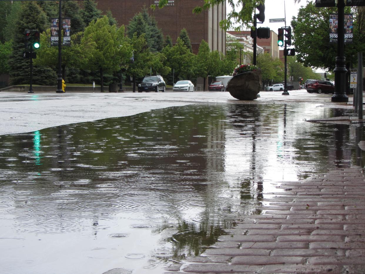 Big puddles are photographed in downtown Great Falls after a storm in June of 2020.