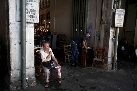 People are seen at the entrance of Athens' main fish market, July 21, 2015. REUTERS/Yiannis Kourtoglou