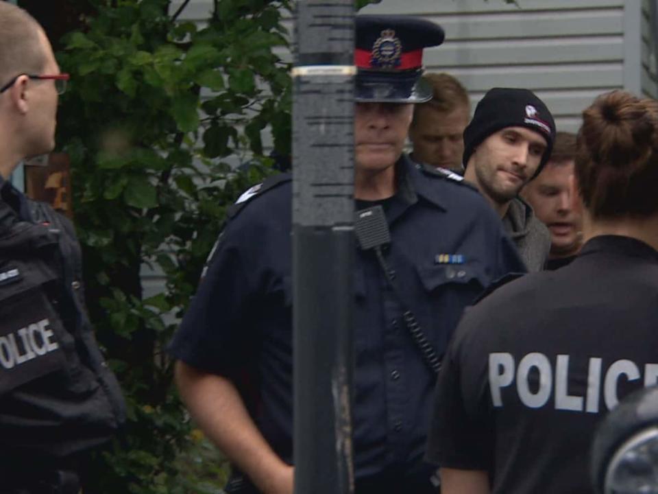 Wade Stene is surrounded by Edmonton police officers in June 2020 as he's taken back into custody.  (CBC  - image credit)