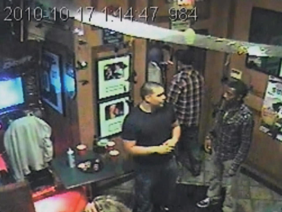 DJ Henry, standing at right, is seen in security footage from inside the bar just minutes before he was  fatally shot. / Credit: Security video