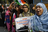 Indians participate in a rally to protest against a new citizenship law, in Kolkata, India, Tuesday, Jan. 21, 2020. India has been embroiled in protests since December, when Parliament passed a bill amending the country's citizenship law. The new law provides a fast track to naturalization for some migrants who entered the country illegally while fleeing religious persecution. But it excludes Muslims, which critics say is discriminatory and a violation of India's Constitution. (AP Photo/Bikas Das)