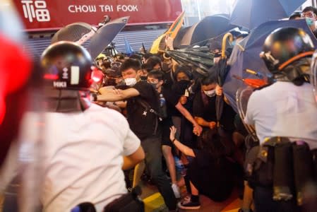 Riot police disperse anti-extradition bill protesters after a march at Hong Kong’s tourism district Nathan Road near Mongkok
