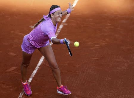 Victoria Azarenka of Belarus plays a shot to Serena Williams of the U.S. during their women's singles match at the French Open tennis tournament at the Roland Garros stadium in Paris, France, May 30, 2015. REUTERS/Pascal Rossignol