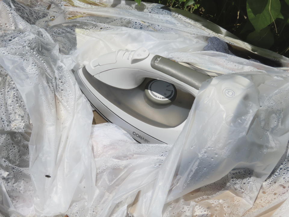 An iron sits atop supplies on the ground in a homeless encampment in Atlantic City, N.J., on Monday, July 1, 2024, the date city officials announced implementation of programs to address homelessness. (AP Photo/Wayne Parry)