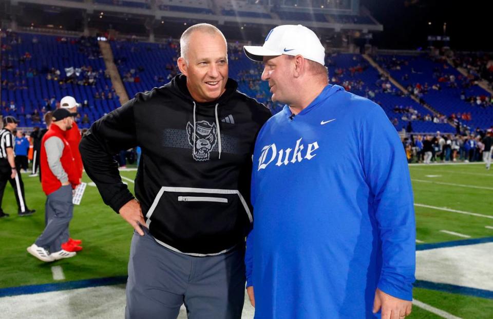N.C. State head coach Dave Doeren talks with Duke head coach Mike Elko before the Wolfpack’s game against the Blue Devils at Wallace Wade Stadium in Durham, N.C., Saturday, Oct. 14, 2023.