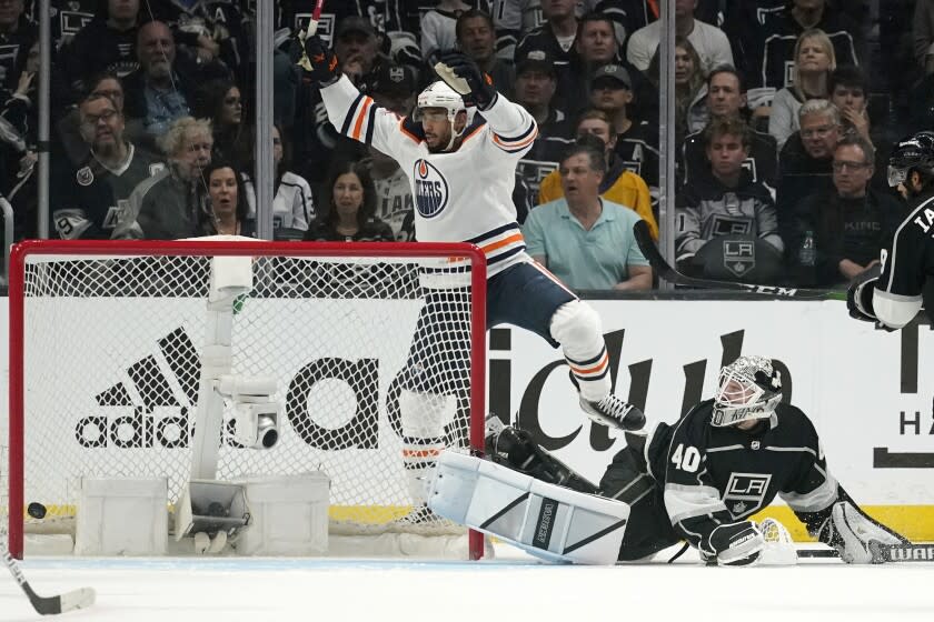 Edmonton Oilers left wing Evander Kane, left, celebrates his goal on Los Angeles Kings goaltender Cal Petersen.