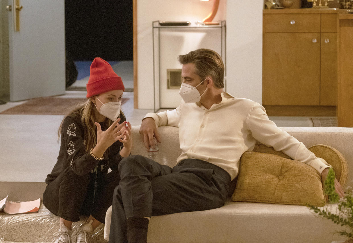 This image released by Warner Bros. Entertainment shows actor-director Olivia Wilde, left, with Chris Pine on the set of "Don't Worry Darling." (Merrick Morton/Warner Bros. Entertainment via AP)