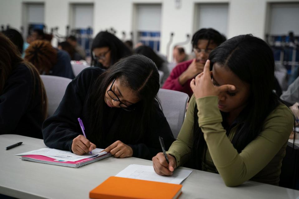 Chelsea Bush, 17, left, and Traniece McWilliams, 17, both of Detroit, take notes during a life skills and financial workshop part of the Midnight Golf Program at Marygrove Conservancy in northwest Detroit, Tuesday, Feb. 7, 2023.