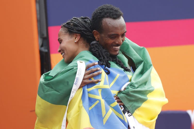 2023 New York Marathon winners Tamirat Tola, of Ethiopia, and Hellen Obiri, of Kenya, congratulate each other Sunday after crossing the finish line in Central Park. Photo by John Angelillo/UPI