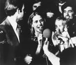 FILE - In this Nov. 7, 1972, file photo, Sen.-elect Joseph Biden, left, gives the microphone to his wife, Neilia Biden, center, in Wilmington, Del. Mrs. Biden and her daughter, Amy Biden, whom she is holding, were killed in a car crash on Dec. 18, 1972. (Jerry Habraken/The News Journal via AP)