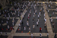 Medical residents take part on a protest against their working conditions during a strike in Barcelona, Spain, Tuesday, Oct. 20, 2020. Regional authorities across Spain continue to tighten restrictions against a sharp resurgence of coronavirus infections that is bringing the country’s cumulative caseload close to one million infections, the highest tally in western Europe. (AP Photo/Emilio Morenatti)