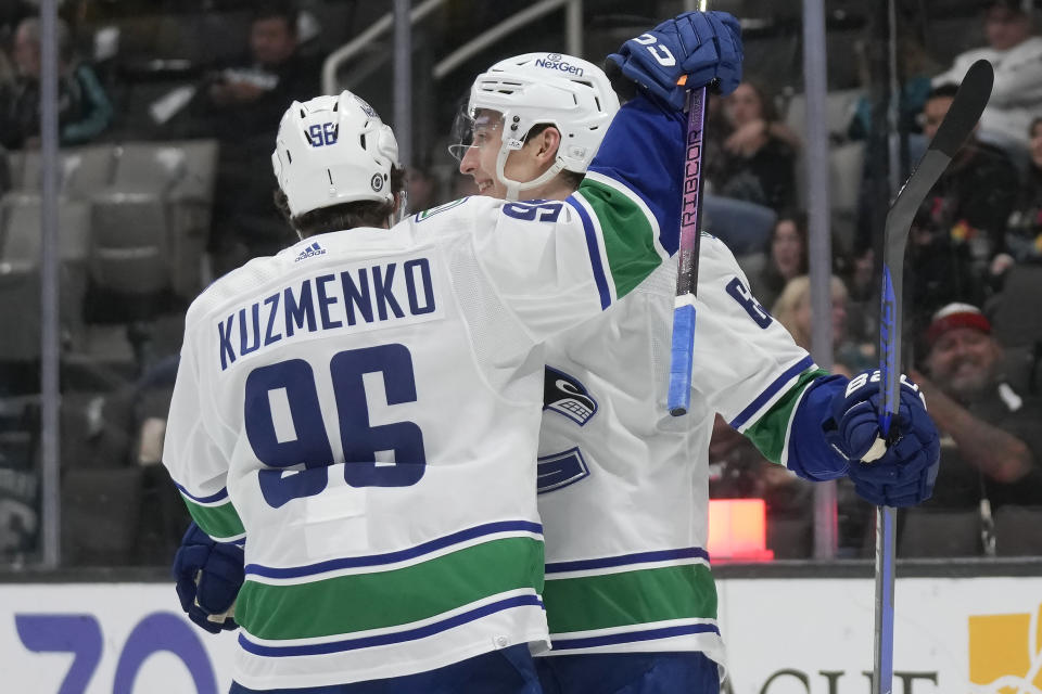 Vancouver Canucks right wing Ilya Mikheyev, right, is congratulated by left wing Andrei Kuzmenko (96) after scoring against the San Jose Sharks during the second period of an NHL hockey game in San Jose, Calif., Thursday, Nov. 2, 2023. (AP Photo/Jeff Chiu)