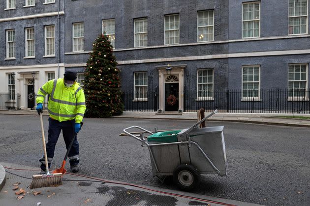 A City of Westminster worker cleans the street in front of 10 Downing Street on December 8, 2021 (Photo: ADRIAN DENNIS via Getty Images)