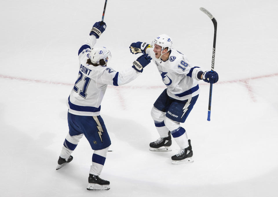 Tampa Bay Lightning left wing Ondrej Palat (18) celebrates his goal against the Dallas Stars with Brayden Point (21) during the second period of Game 3 of the NHL hockey Stanley Cup Final, Wednesday, Sept. 23, 2020, in Edmonton, Alberta. (Jason Franson/The Canadian Press via AP)