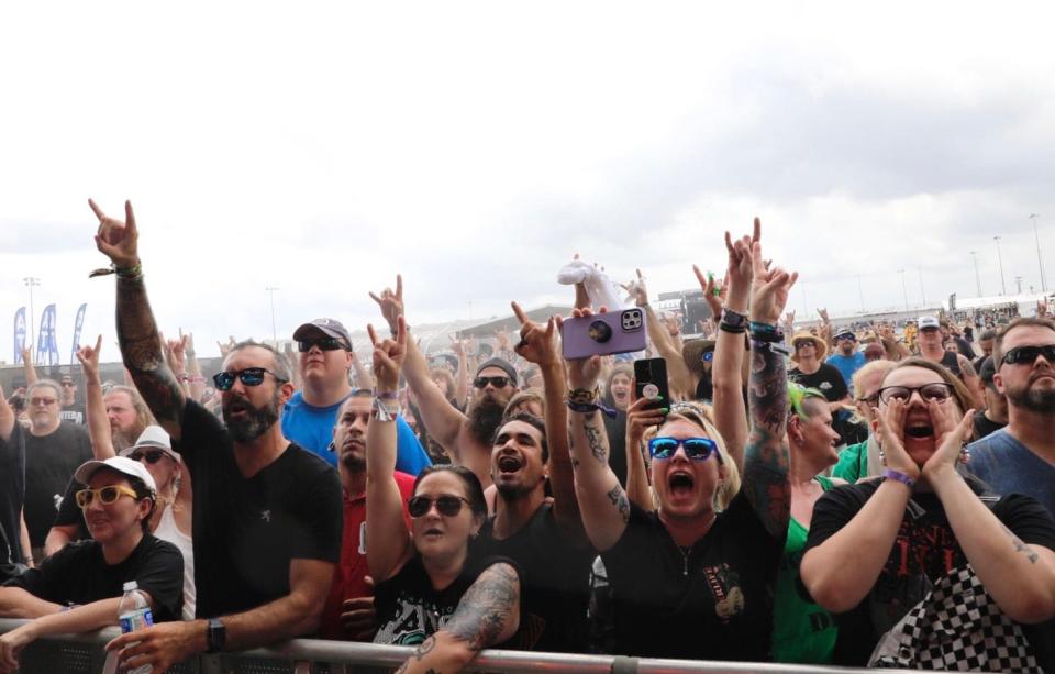 Fist-pumping fans crowd the stage on Saturday at the Welcome to Rockville music festival at Daytona International Speedway. Later in the day, the event again was besieged by a series of severe thunderstorms that forced the show to shut down early before the scheduled headlining set by Guns N' Roses.