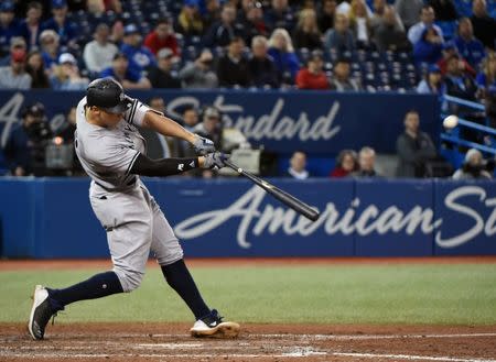 Jun 6, 2018; Toronto, Ontario, CAN; New York Yankees right fielder Aaron Judge (99) hits a two run home run against Toronto Blue Jays in the 13th inning at Rogers Centre. Mandatory Credit: Dan Hamilton-USA TODAY Sports