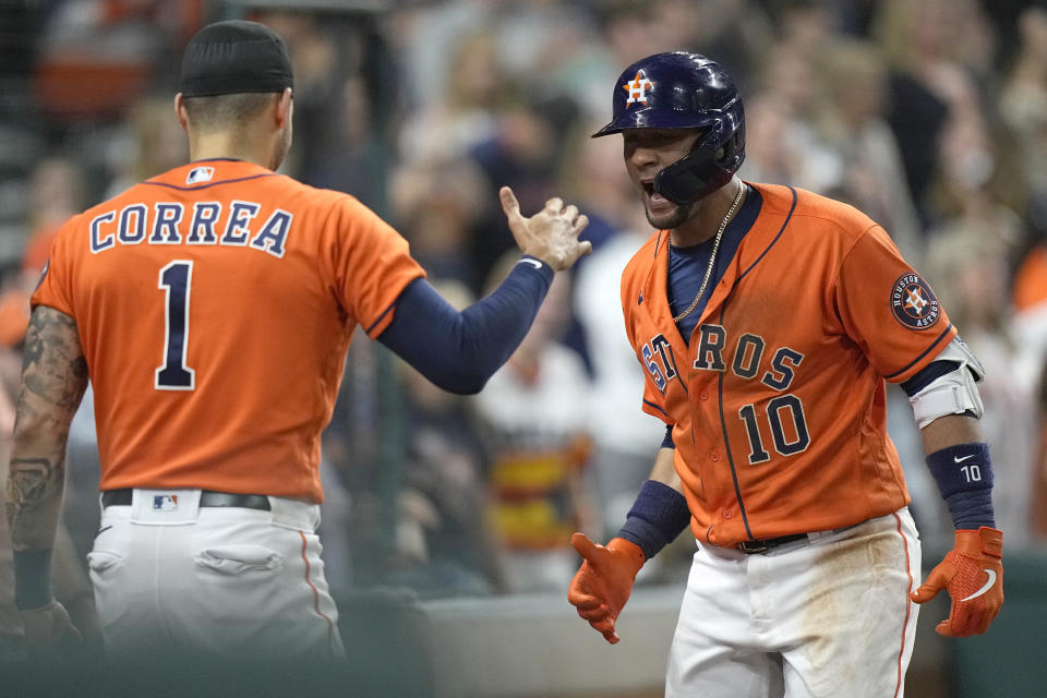 Houston Astros' Yuli Gurriel (10) celebrates with Carlos Correa (1) after hitting a two-run home run against the Los Angeles Angels during the seventh inning of a baseball game Friday, April 23, 2021, in Houston. (AP Photo/David J. Phillip)