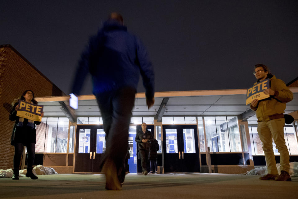 People arrive for caucus at Roosevelt Hight School, Monday, Feb. 3, 2020, in Des Moines, Iowa. (AP Photo/Andrew Harnik)