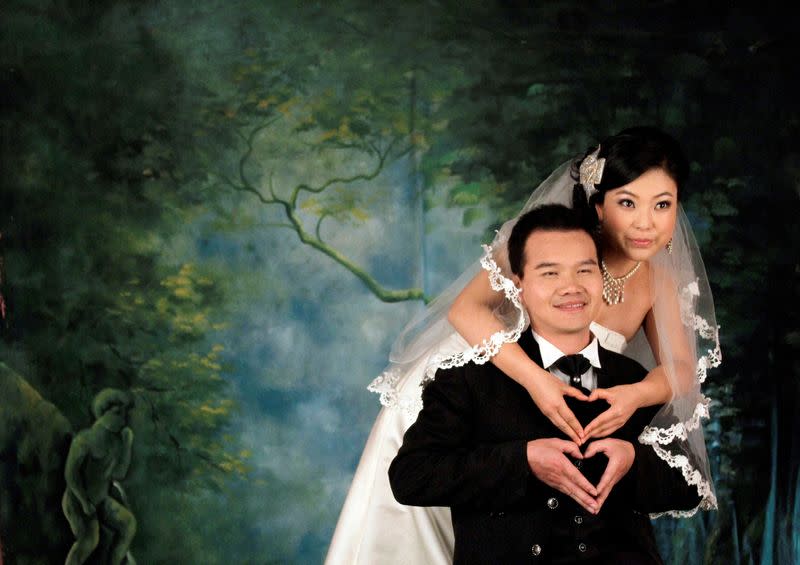 FILE PHOTO: A Chinese couple pose for their wedding photographs
