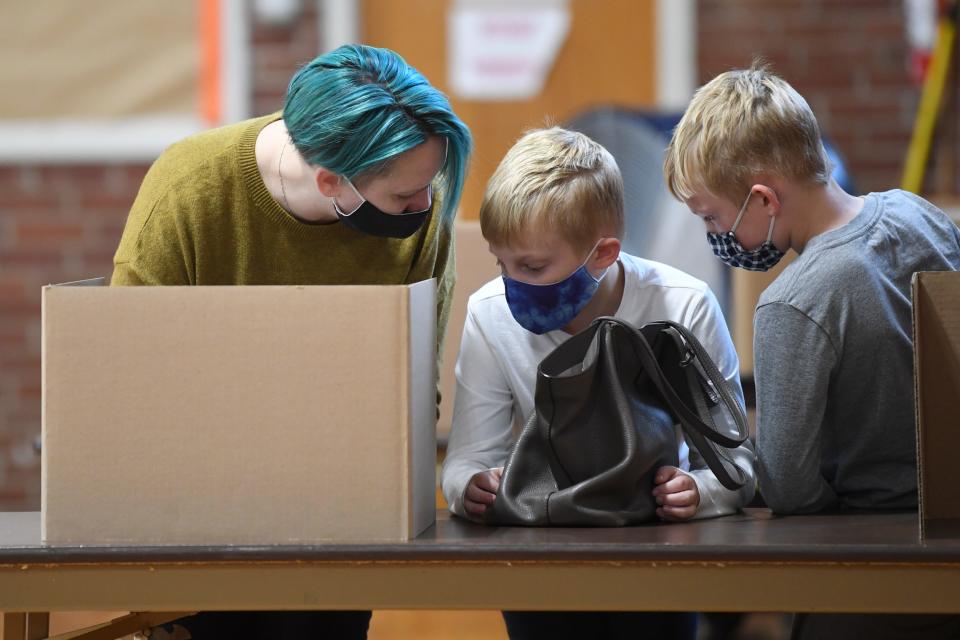 Misty Brown votes with her sons Rory and Jasper, both 9, at the Richard Yoakley School polling location in 2021.