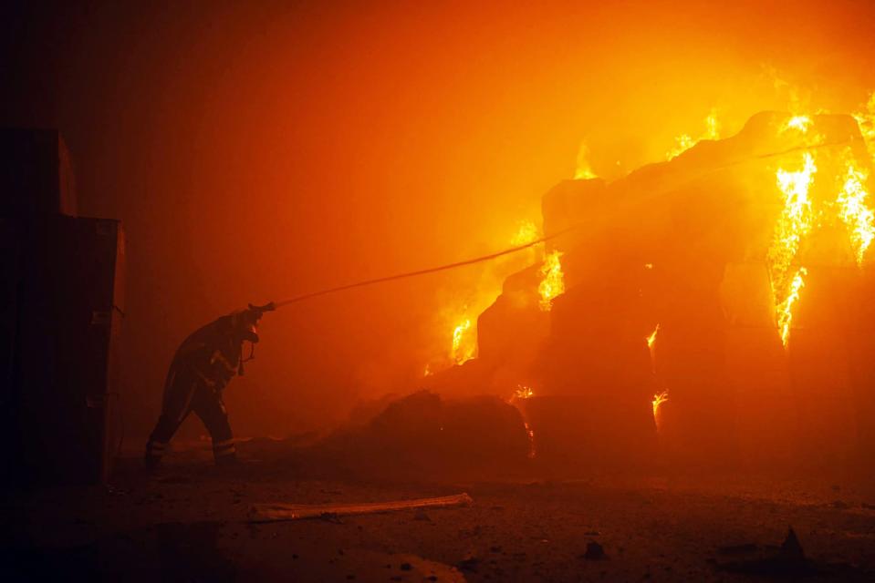 Rescuer putting out a fire in a building as a result of falling debris after a massive drone attack mainly targeting Kyiv (State Emergency Service of Ukraine)