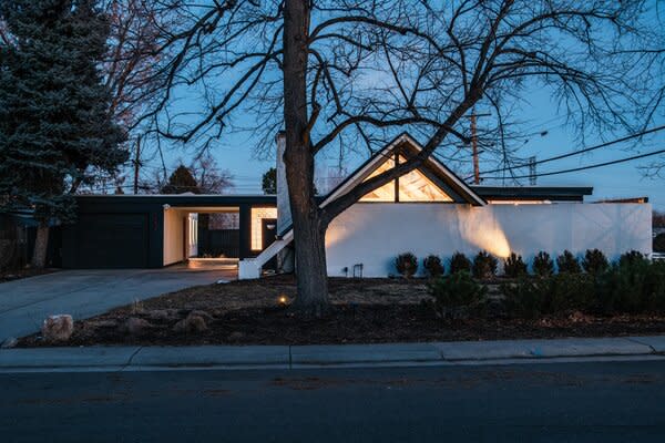 The home’s eye-catching facade features glass bricks and an A-frame roof.