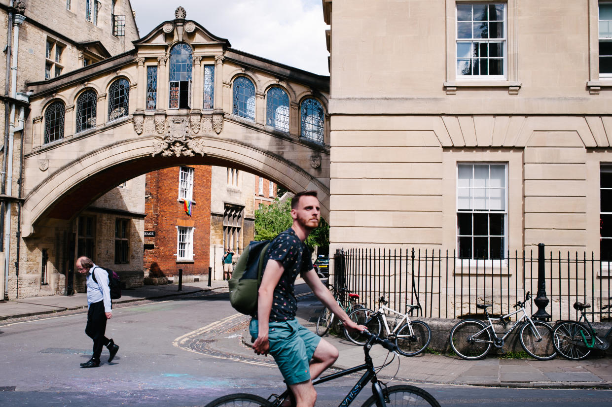 Cyclists and pedestrians pass the Hertford Bridge, typically known as the 'Bridge of Sighs', on New College Lane in Oxford, England, on June 22, 2019. (Photo by David Cliff/NurPhoto via Getty Images)