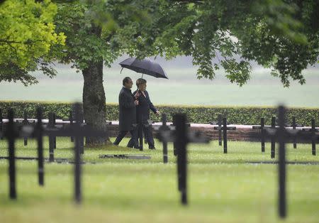 French President Francois Hollande and German Chancellor Angela Merkel walk at a German cemetery in Consenvoye near Verdun, France, May 29, 2016, during a remembrance ceremony marking the 100th anniversary of the battle of Verdun, one of the largest battles of the First World War (WWI) on the Western Front. REUTERS/Jean-Christophe Verhaegen/Pool